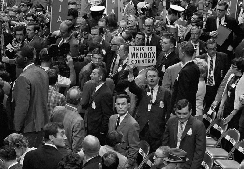 Delegate Jack Dorsey of Tucker holds up a sign in proclaiming his views concerning which Georgia delegation, the one headed by Gov. Lester G. Maddox or that led by Julian Bond, he thought was entitled to represent the state at the 1968 Democratic National Convention in Chicago.  Maddox had used his powerful influence to pack the delegation with like-minded segregationist Georgians, although there were also some Black members within the group. (AP Photo)