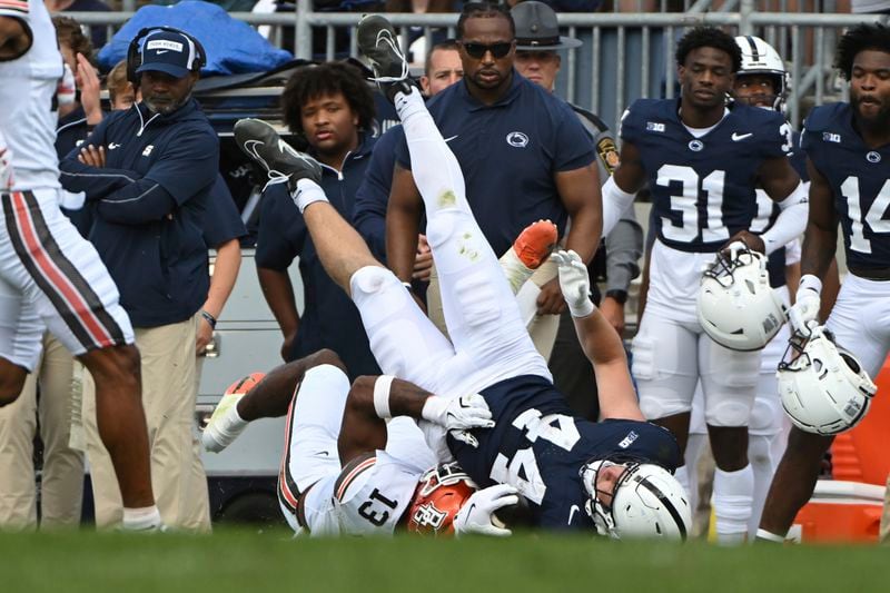 Bowling Green linebacker Charles Rosser (13) upends Penn State tight end Tyler Warren (44) during the second quarter of an NCAA college football game against Penn State, Saturday, Sept. 7, 2024, in State College, Pa. (AP Photo/Barry Reeger)