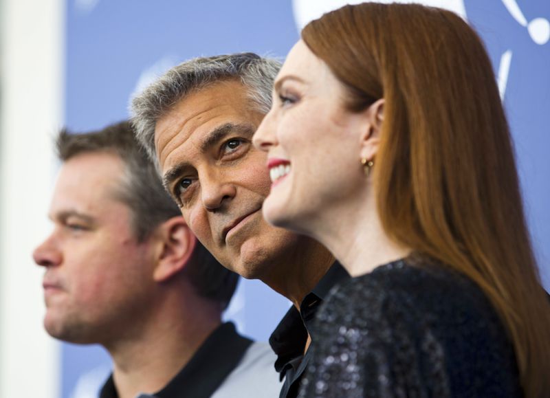 FILE - Actor George Clooney, center, poses with actors, Julianne Moore, right, and Matt Damon during the photo call for the film "Suburbicon" at the 74th Venice Film Festival in Venice, Italy on Sept. 2, 2017. (AP Photo/Domenico Stinellis, File)