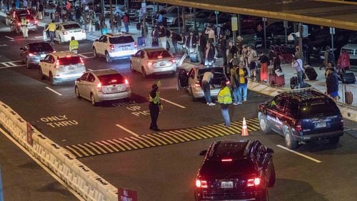 Uber and Lyft drivers pick up passengers at the Rideshare location at Hartsfield-Jackson International Airport, Thursday, Nov. 9, 2017, in Atlanta. BRANDEN CAMP/SPECIAL