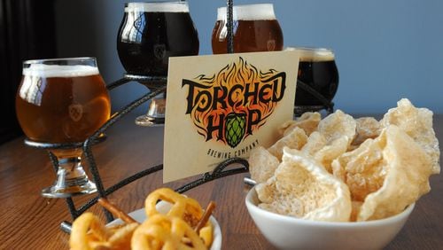 Torched Hop Brewing Co. duck fat chef mix and salt and vinegar pork rinds with a flight of beers: Belgian Golden, Scottish Ale, IPA and Milk Stout. (Beckysteinphotography.com)