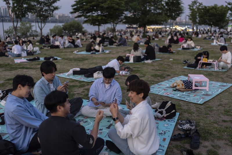 People spend time in Yeouido Hangang Park, a popular destination for both residents and tourists, in Seoul, Wednesday, May 22, 2024. (AP Photo/Jae C. Hong)