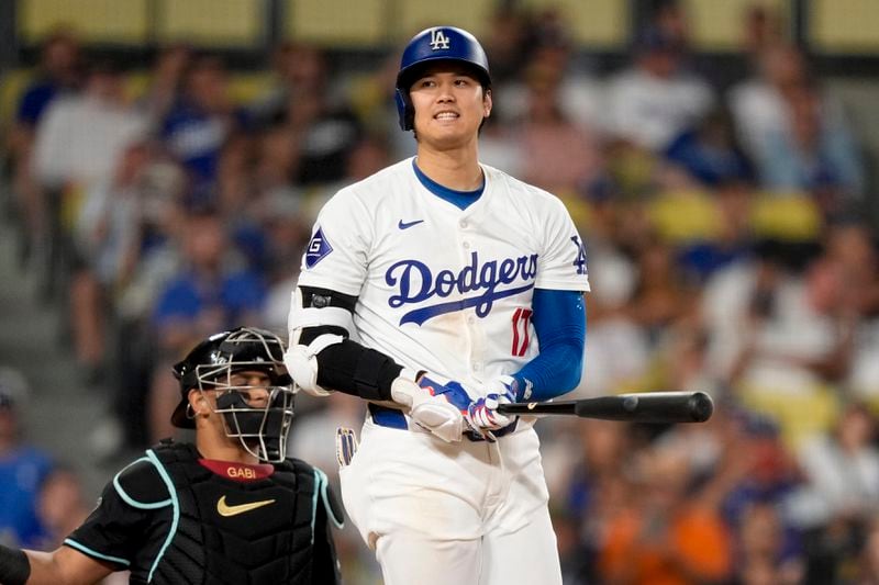 Los Angeles Dodgers designated hitter Shohei Ohtani reacts after a swinging strike during the ninth inning of a baseball game against the Arizona Diamondbacks, Tuesday, July 2, 2024, in Los Angeles. (AP Photo/Ryan Sun)