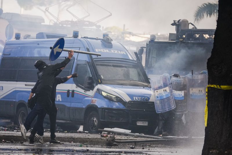 Italian Police and demonstrators clash during a march in support of the Palestinian people in Rome, Saturday, Oct. 5, 2024, two days before the anniversary of Hamas-led groups attack in Israeli territory outside of Gaza on Oct. 7, 2023. (AP Photo/Andrew Medichini)