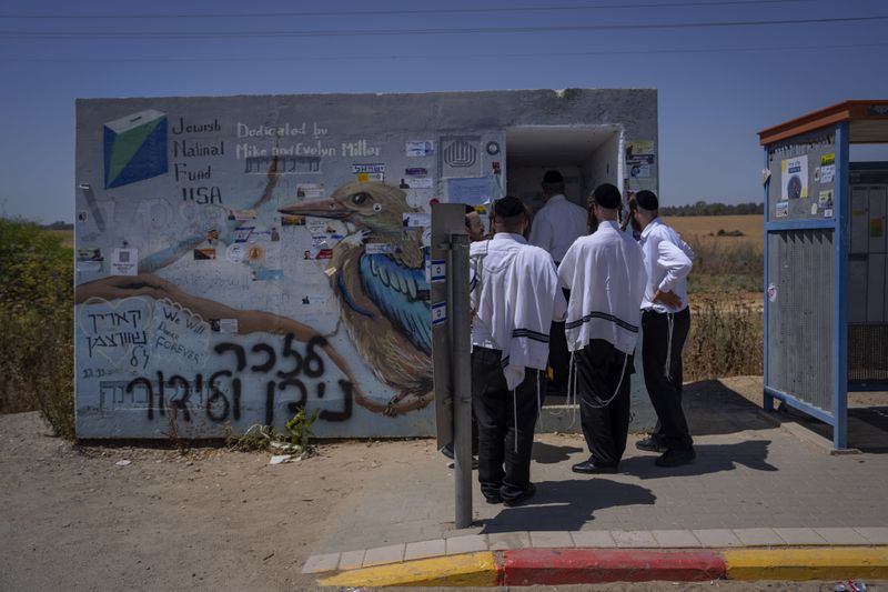 Ultra-Orthodox Jews from central Israel visit a bomb shelter where Israelis were killed during the Oct. 7 Hamas militants attack on Israel, near Kibbutz Beeri, southern Israel, on Friday, June 21, 2024. A new kind of tourism has emerged in Israel in the months since Hamas’ Oct. 7 attack. For celebrities, politicians, influencers and others, no trip is complete without a somber visit to the devastated south that absorbed the brunt of the assault near the border with Gaza. (AP Photo/Oded Balilty)