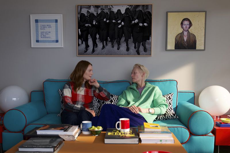 This image released by Sony Pictures Classics shows Julianne Moore, left, and Tilda Swinton in a scene from "The Room Next Door." (Sony Pictures Classics via AP)