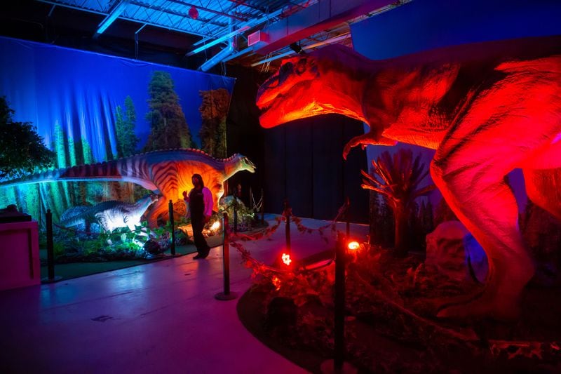 People walk through the Dino Safari exhibit at Northpoint mall in Alpharetta Friday, November 19, 2021.STEVE SCHAEFER FOR THE ATLANTA JOURNAL-CONSTITUTION