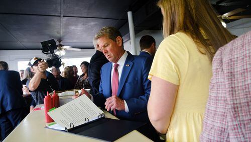 Gov. Brian Kemp reviews notes at the White Diamond Grill in Bonaire before he signs a $1 billion tax cut bill on Tuesday, April 26, 2022.   (Arvin Temkar / arvin.temkar@ajc.com)