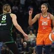 Connecticut Sun forward Alyssa Thomas (25) handles the ball against Minnesota Lynx forward Alanna Smith (8) during the second half of Game 1 of a WNBA basketball semifinals series Sunday, Sept. 29, 2024, in Minneapolis. (AP Photo/Stacy Bengs)