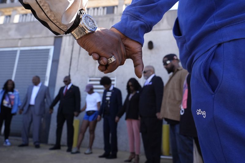 Family and friends of Tyre Nichols gather for a prayer vigil outside the federal courthouse as jury deliberations begin for the trial of three former Memphis police officers charged in the 2023 fatal beating of Nichols, Thursday, Oct. 3, 2024, in Memphis, Tenn. (AP Photo/George Walker IV)