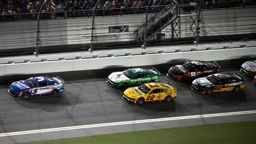 Kyle Larson (5) leads Todd Gilliland (38), Joey Logano (22), Kyle Busch (8) and Ryan Blaney (12) through the front stretch during a NASCAR Cup Series auto race at Daytona International Speedway, Saturday, Aug. 24, 2024, in Daytona Beach, Fla. (AP Photo/Phelan M. Ebenhack)