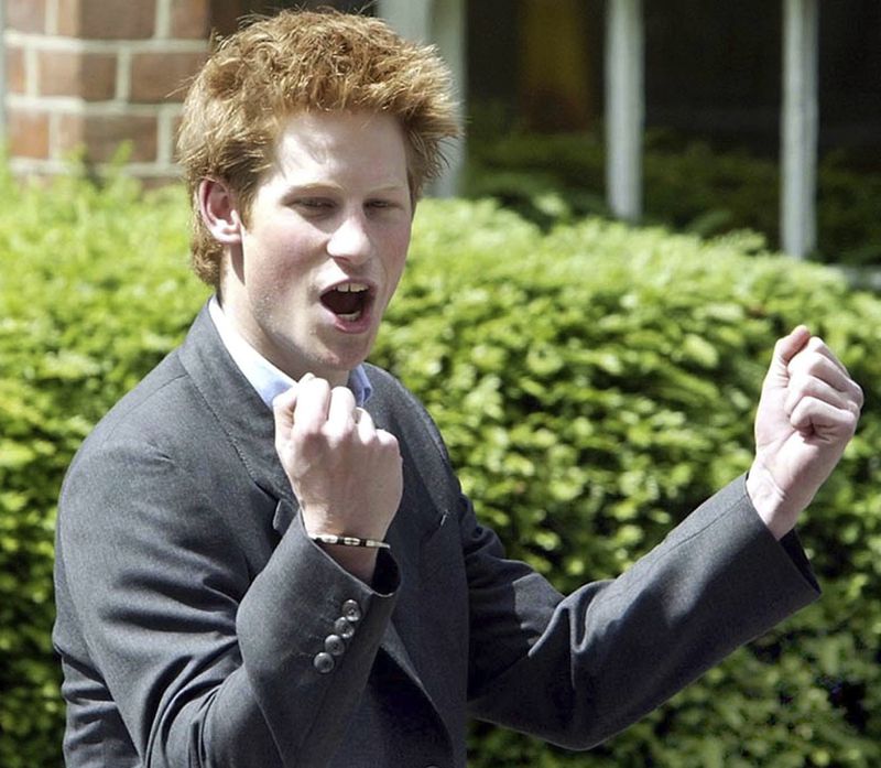 FILE - Britain's Prince Harry, 18, punches the air as he leaves Eton College on his last day at the top public school where he has been a pupil for five years, in Windsor, England, on June 12, 2003. (AP Photo/Dave Caulkin, File)