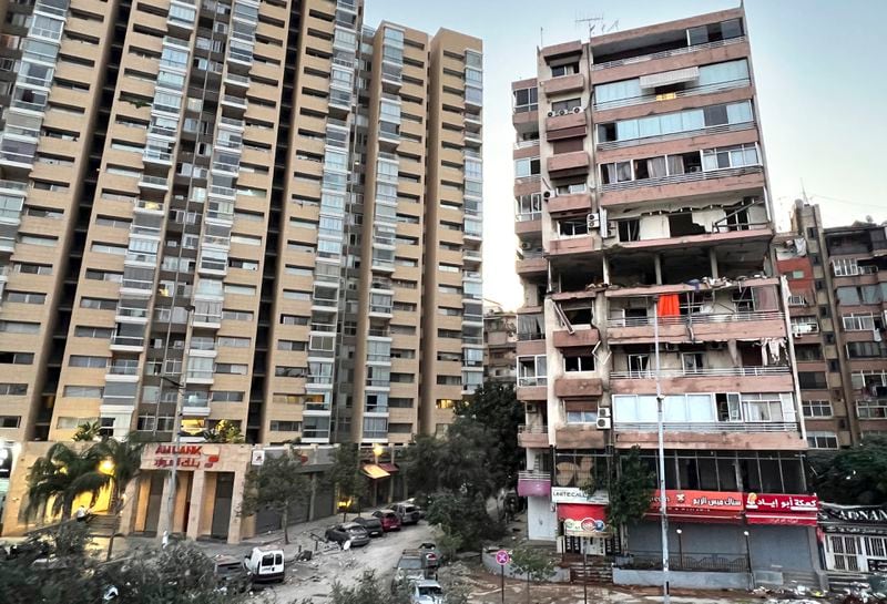 Damaged apartments, right, are seen in a building that was hit by Israeli strike, in Beirut, Lebanon, early Monday, Sept. 30, 2024. (AP Photo/Hussein Malla)