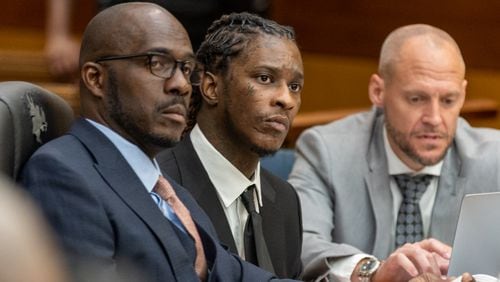 Atlanta rapper Young Thug (center), whose real name is Jeffery Williams, makes his first in-person appearance at the Fulton County Courthouse in Atlanta on Thursday, December 15, 2022. He was named in a RICO indictment earlier this year. (Arvin Temkar / arvin.temkar@ajc.com)