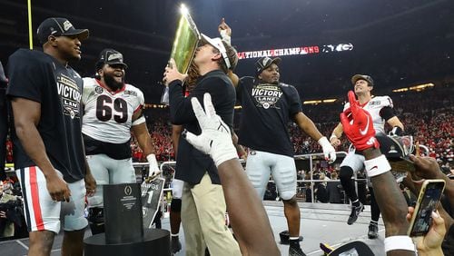 Georgia head coach Kirby Smart kisses the trophy after his team won the College Football Playoff championship game over Alabama on Monday, Jan. 10, 2022, in Indianapolis.  “Curtis Compton / Curtis.Compton@ajc.com”`