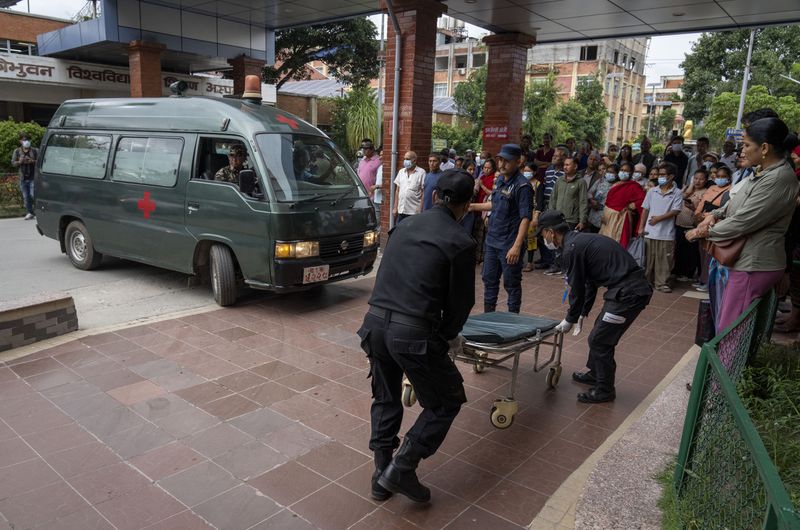 An ambulance carrying injured people arrives for treatment at a hospital, after a bus carrying Indian tourists fell into a river near Abukhaireni town about 75 miles west of the capital Kathmandu, Nepal, Friday, Aug. 23, 2024. (AP Photo/Niranjan Shrestha)