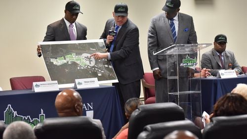 Craig Delasin (center), CEO of Urban Retail Properties, explains as Patrick Henderson (left), CEO of Atlanta Sports Connection, and Zeric Foster, COO of Atlanta Sports Connection, stand next him during a press conference on May 17, 2017. Developers and tourism officials revealed plans for medical facilities and retail at Atlanta Sports City. HYOSUB SHIN / HSHIN@AJC.COM