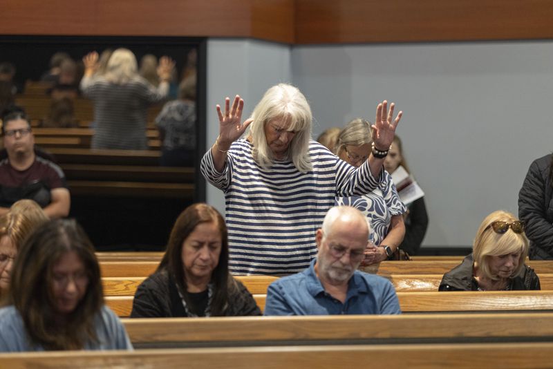 Audience members pray with Pastor Jack Hibbs at a Comeback California Tour event at Revival Fellowship, Saturday, Sept. 21, 2024, in Menifee, Calif. (AP Photo/Zoë Meyers)