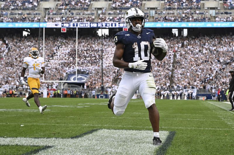 Penn State running back Nicholas Singleton (10) scores a touchdown while being chased by Kent State cornerback Dallas Branch (15) during the second quarter of an NCAA college football game, Saturday, Sept. 21, 2024, in State College, Pa. (AP Photo/Barry Reeger)