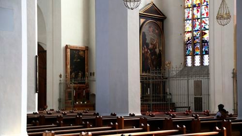FILE - A man sits in the empty 'Church of our Lady' in Munich, Germany, Thursday, March 19, 2020. Another 400,000 people formally left the Catholic Church in Germany last year, though the number was down from a record set in 2022 as church leaders struggle to put a long-running scandal over abuse by clergy behind them and tackle calls for reform, official figures showed Thursday, June 27, 2024. (AP Photo/Matthias Schrader, File)