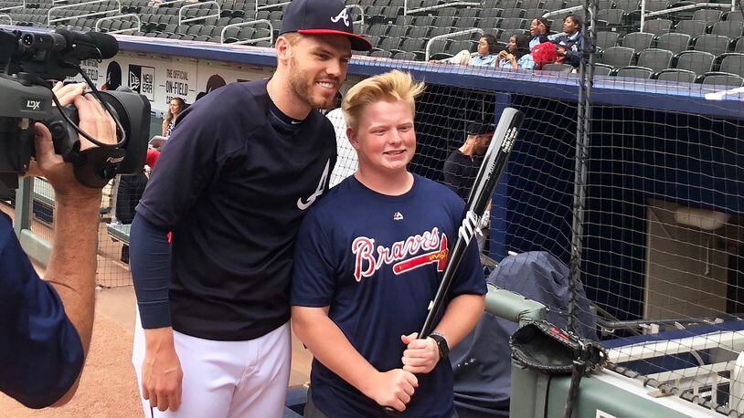 Baseball player Freddie Freeman surprises a young Phillies fan who