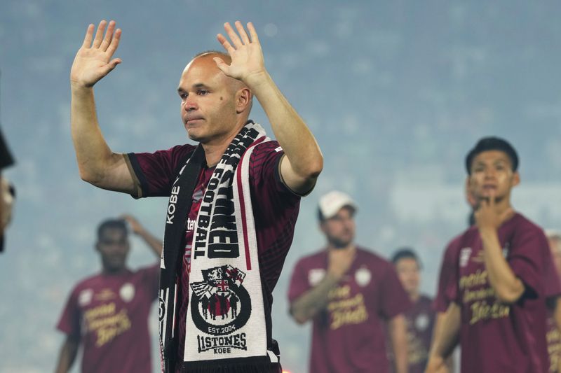 FILE - Vissel Kobe midfielder Andres Iniesta waves towards audience members at the end of a farewell ceremony to commemorate his leaving the club, after his last match with the club against Consadole Sapporo in Kobe, Japan, Saturday, July 1, 2023. Andres Iniesta who scored Spain's World Cup-winning goal in 2010 and was one of the key players who made Barcelona's tiki-taka thrive for so long, announced his retirement from soccer on Tuesday. (AP Photo/Hiro Komae, File)