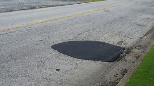 A dangerous pothole is no more in DeKalb County after the public works department fixed it. (Photo/DeKalb County)