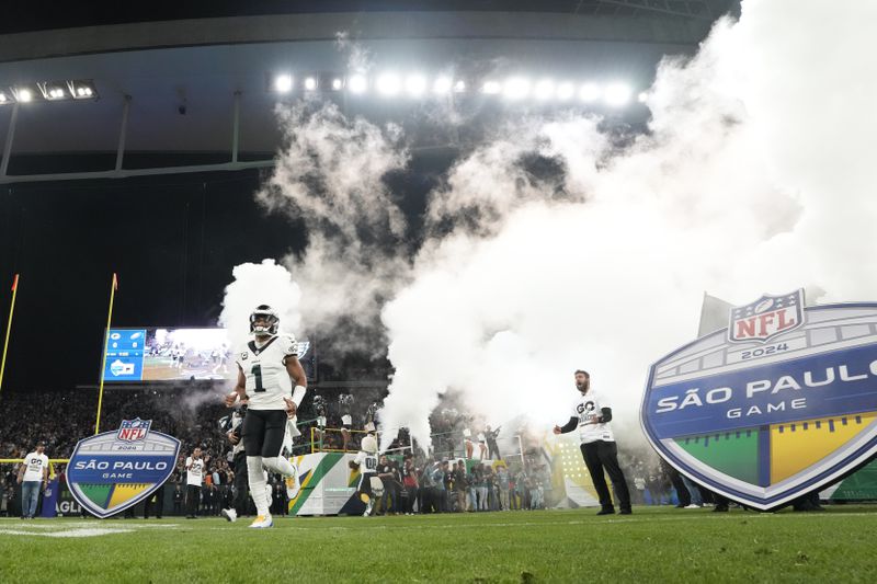 Philadelphia Eagles quarterback Jalen Hurts (1) runs onto the field before NFL football game between the Philadelphia Eagles and the Green Bay Packers, Friday, Sept. 6, 2024, at the Neo Quimica Arena in Sao Paulo. (AP Photo/Doug Benc)