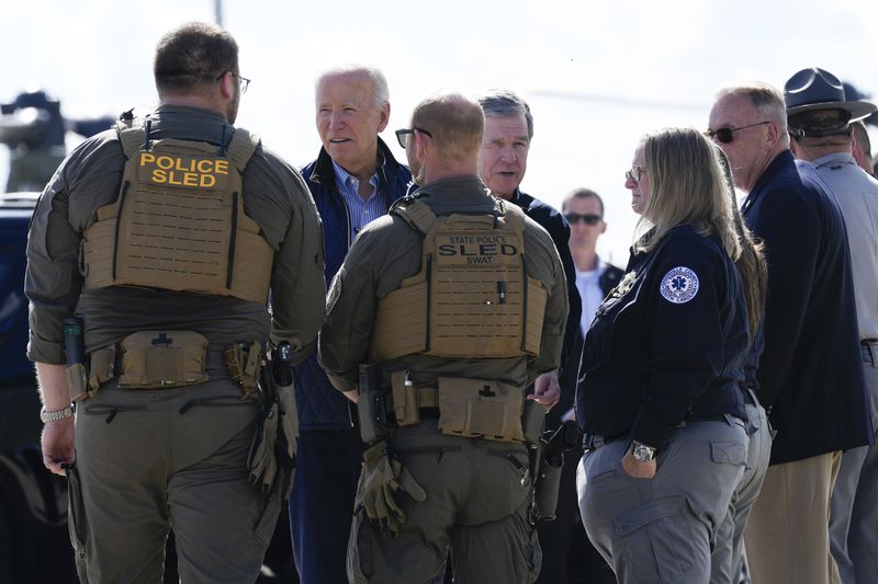 President Joe Biden and Gov. Roy Cooper, D-N.C., greet first responders after touring areas impacted by Hurricane Helene, at the ariport in Greenville, S.C., Wednesday, Oct. 2, 2024. (AP Photo/Susan Walsh)