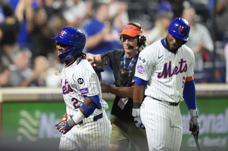 New York Mets' Luisangel Acuña (2) celebrates with Starling Marte, right, after hitting a home run during the eighth inning of a baseball game against the Washington Nationals, Tuesday, Sept. 17, 2024, in New York. (AP Photo/Frank Franklin II)