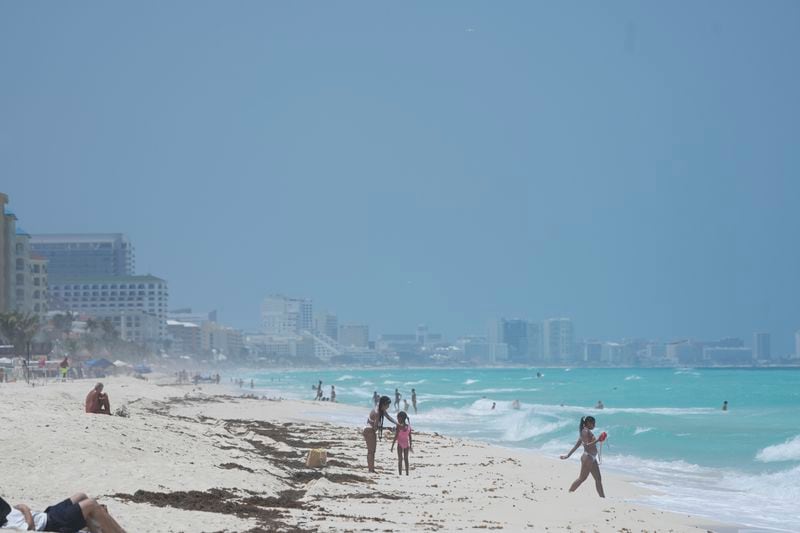Tourists lounge on the beach ahead of Hurricane Beryl's expected arrival in Cancun, Mexico, Wednesday, July 3, 2024. (AP Photo/Fernando Llano)