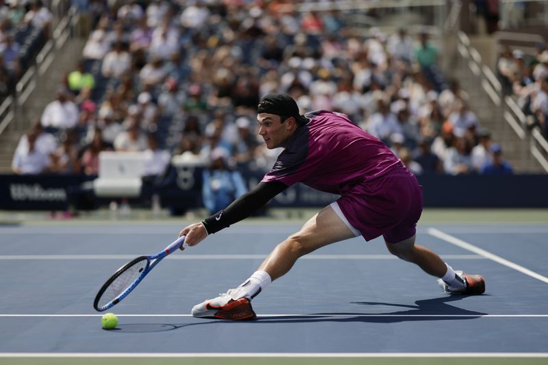 Jack Draper, of Great Britain, misses a shot from Botic van De Zandschulp, of the Netherlands, during the third round of the U.S. Open tennis championships, Saturday, Aug. 31, in New York. 2024. (AP Photo/Adam Hunger)