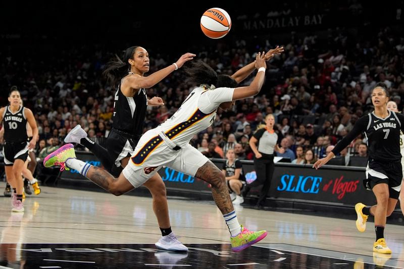 Las Vegas Aces center A'ja Wilson, left, fouls Indiana Fever forward NaLyssa Smith during the second half of a WNBA basketball game Saturday, May 25, 2024, in Las Vegas. (AP Photo/John Locher)