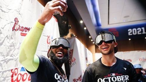 Atlanta Braves designated hitter Marcell Ozuna (20) takes a selfie with Matt Olson (28) in the locker rooms. 
(Miguel Martinez/ AJC)