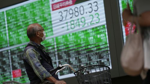 A man looks at monitors showing Japan's Nikkei 225 index at a securities firm in Tokyo, Monday, Sept. 30, 2024. (AP Photo/Hiro Komae)