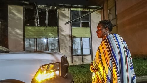 Barbara Lampkin stands outside her apartment after a fire broke out early Tuesday in southwest Atlanta, officials said.