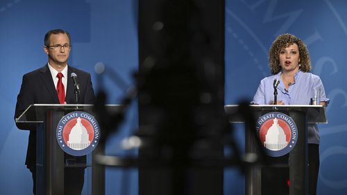 FILE - Rep. Celeste Maloy, R-Utah, speaks as Colby Jenkins looks on during Utah's 2nd Congressional district debate June 10, 2024, at the University of Utah, in Salt Lake City. Jenkins formally requested the recount in the election on Monday, July 29, but followed it up late Tuesday, July 30, with a lawsuit contesting the certification of results over 1,171 ballots that had been disqualified for late postmarking. (Scott G. Winterton/The Deseret News via AP, Pool, File)