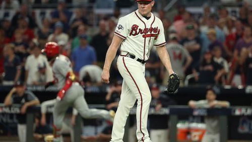 Braves relief pitcher Mark Melancon reacts after giving up a two-run double to the Cardinals’ Marcell Ozuna.