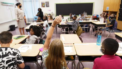 FILE - A student raises their hand in a classroom at Tussahaw Elementary school Aug. 4, 2021, in McDonough, Ga. According to test results released by the Georgia Department of Education on Friday, July 26, 2024, Georgia students in some grades approached pre-pandemic scores in the 2023-2024 school year, while other grades did not. (AP Photo/Brynn Anderson, File)