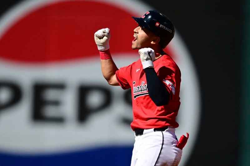 Cleveland Guardians left fielder Steven Kwan celebrates his double at second base in the first inning during Game 1 of the baseball's American League Division Series against the Detroit Tigers, Saturday, Oct. 5, 2024, in Cleveland. (AP Photo/David Dermer)