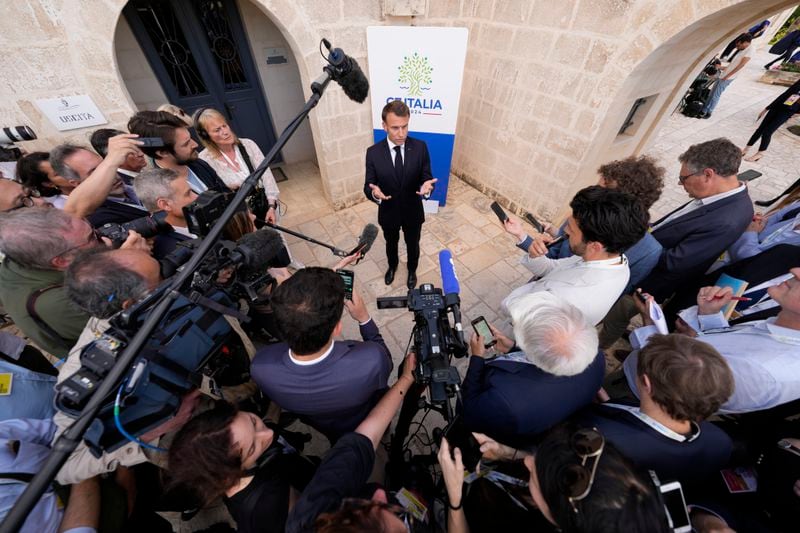 French President Emmanuel Macron, speaks to journalists at the G7 in Borgo Egnazia near Bari in southern Italy, Thursday, June 13, 2024. (AP Photo/Domenico Stinellis)