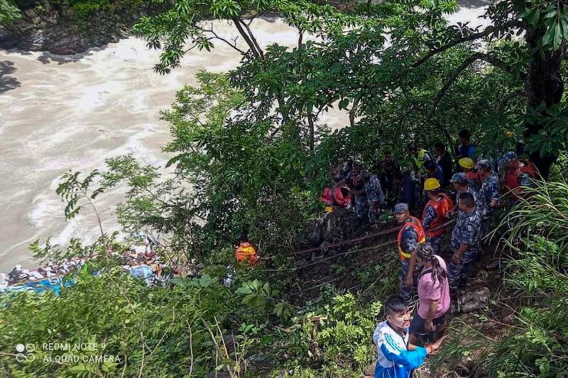 This photograph provided by Nepal Armed Police Force (APF) shows APF personnel carrying out rescue operation after a bus carrying Indian pilgrims fell into a river near Abukhaireni town, about 75 miles west of the capital, Kathmandu, Nepal, Friday, Aug. 23, 2024. (Nepal Armed Police Force via AP)