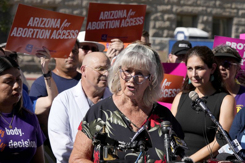 Pamela Hill speaks as she joins Arizona abortion-rights supporters at a news conference prior to delivering over 800,000 petition signatures to the capitol to get abortion rights on the November general election ballot Wednesday, July 3, 2024, in Phoenix. (AP Photo/Ross D. Franklin)