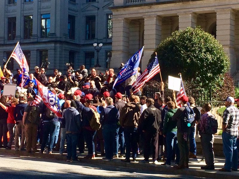 Noted conspiracy theorist Alex Jones and some 150 protestors pack the sidewalk on Wednesday, Nov. 18, 2020, in Atlanta outside the Georgia Capitol. Masks were rare. Photo by Bill Torpy