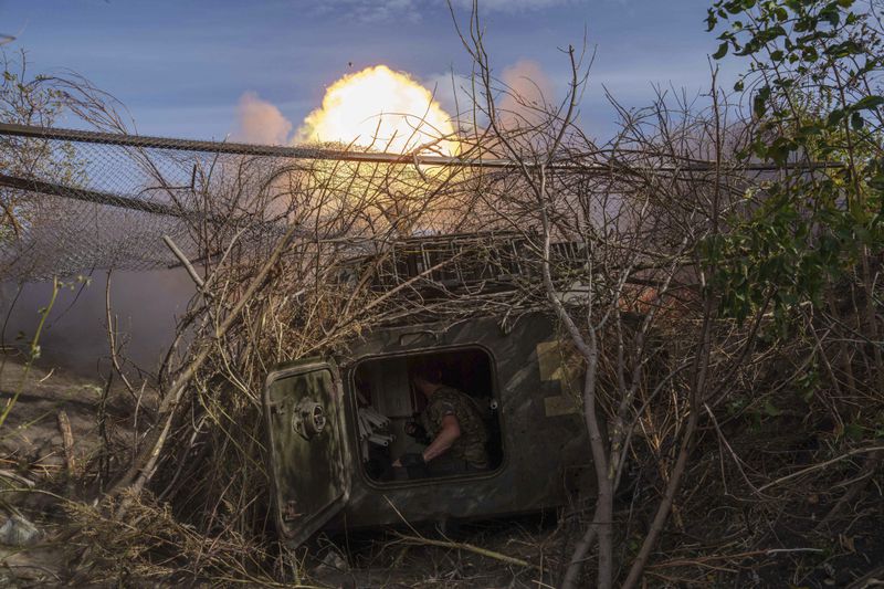 Ukrainian serviceman of 56th brigade fire by self-propelled artillery towards Russian positions at the frontline on Chasiv Yar direction, Donetsk region, Ukraine, Sept. 27, 2024. (AP Photo/Evgeniy Maloletka)