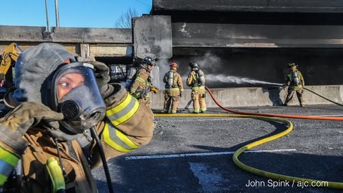 Fire crews continue to battle smoking debris at site of I-85 collapse Friday, March 31, 2017, in Midtown Atlanta.