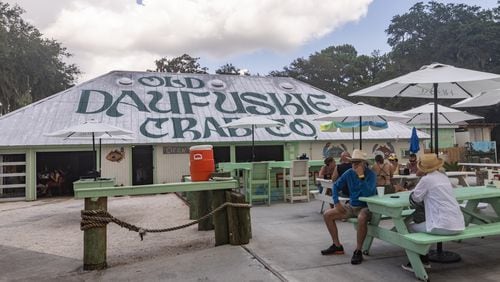 Patrons at Old Daufuskie Crab Co. wait for their orders to arrive. This eatery in Daufuskie Island, South Carolina, is known for deviled crab and a cocktail called a Scrap Iron. (Katelyn Myrick for The Atlanta Journal-Constitution)