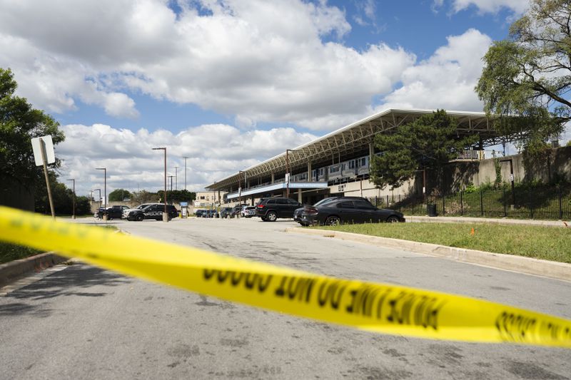 Yellow tape blocks off the parking lot of the Forest Park Blue Line train station in Forest Park, Ill., after four people were fatally shot on the train early Monday, Sept. 2, 2024. (Pat Nabong/Chicago Sun-Times via AP)