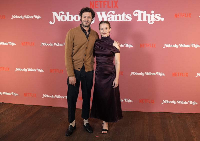 FILE - Adam Brody, left, and Kristen Bell, cast members in "Nobody Wants This," pose together at a photo call for the Netflix series at The Aster hotel, Wednesday, Sept. 18, 2024, in Los Angeles. (AP Photo/Chris Pizzello, File)