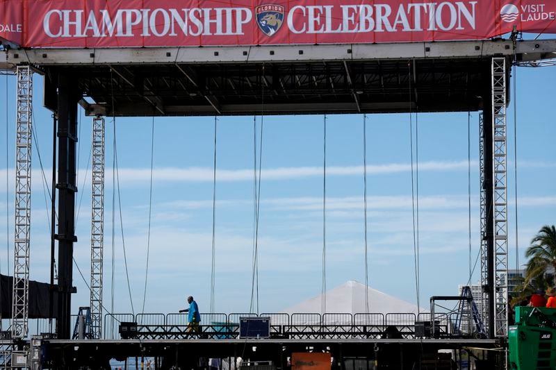 A worker walks across a temporary stage set up in preparation for the Florida Panthers Stanley Cup Celebration on Fort Lauderdale Beach on Friday, June 28, 2024. (Amy Beth Bennett /South Florida Sun-Sentinel via AP)